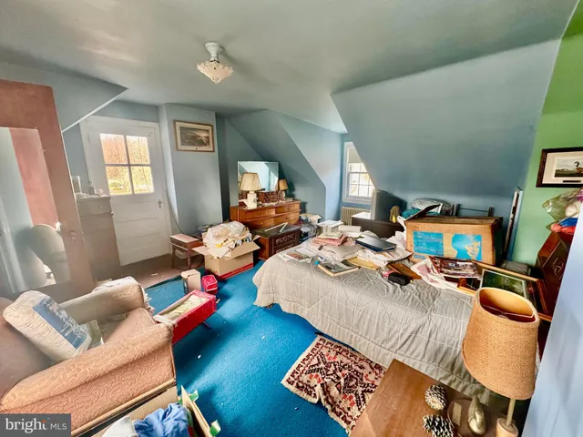 a bedroom with furniture and a wooden floor