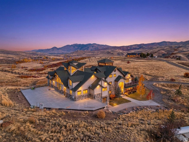 246 Woods Creek Road Morgan, UT 84050 - Photo 3 of 69 Multi-level residence featuring stone and stucco exterior, multiple gables, extensive window placement, and a circular turret