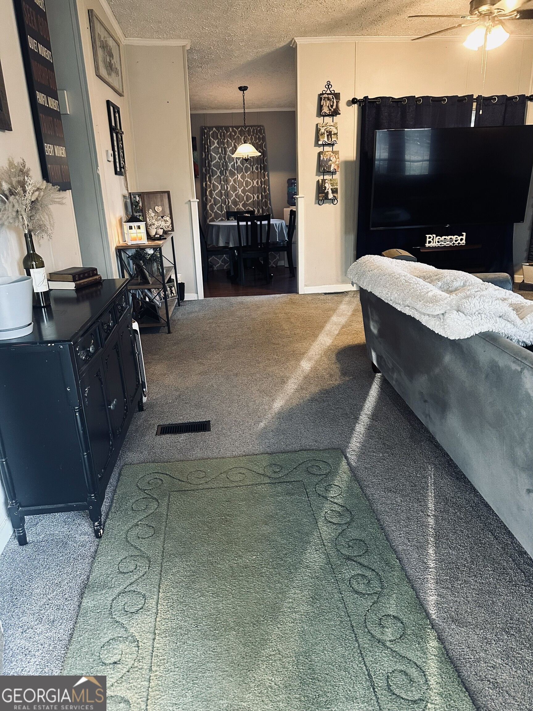 6675 Millwood Road, Unit 1B Gainesville, GA 30506 - Photo 3 of 10 a living room with furniture and a flat screen tv
