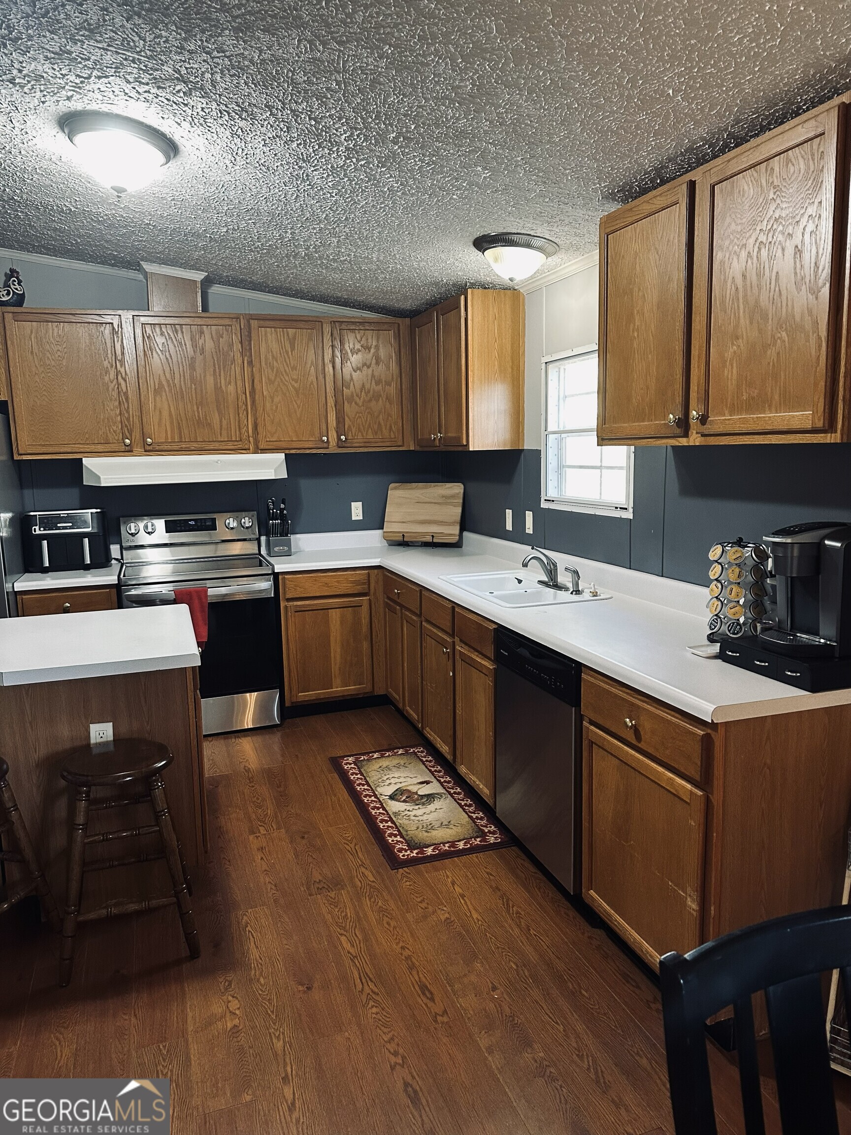 6675 Millwood Road, Unit 1B Gainesville, GA 30506 - Photo 6 of 10 a kitchen with a sink stove and cabinets