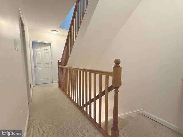 a view of a hallway with wooden floor and entryway
