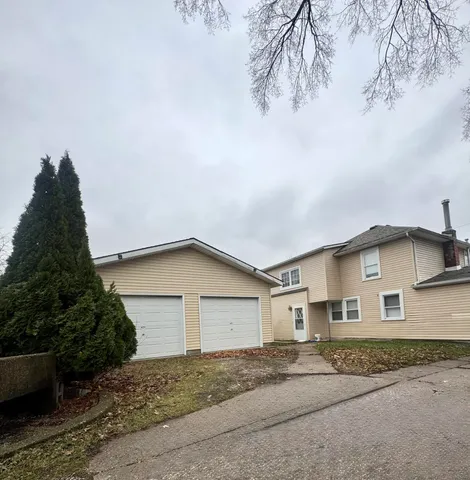 a view of a house with a yard and garage