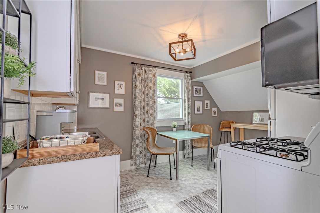 238 East Schaaf Road Independence, OH 44131 - Photo 25 of 39 Dining area with a chandelier and vaulted ceiling