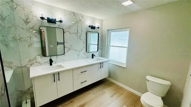 a bathroom with a mirror a glass door shower and a mirror