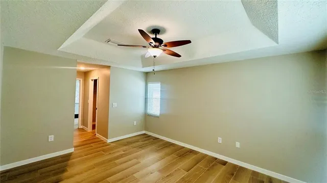a view of empty room with wooden floor