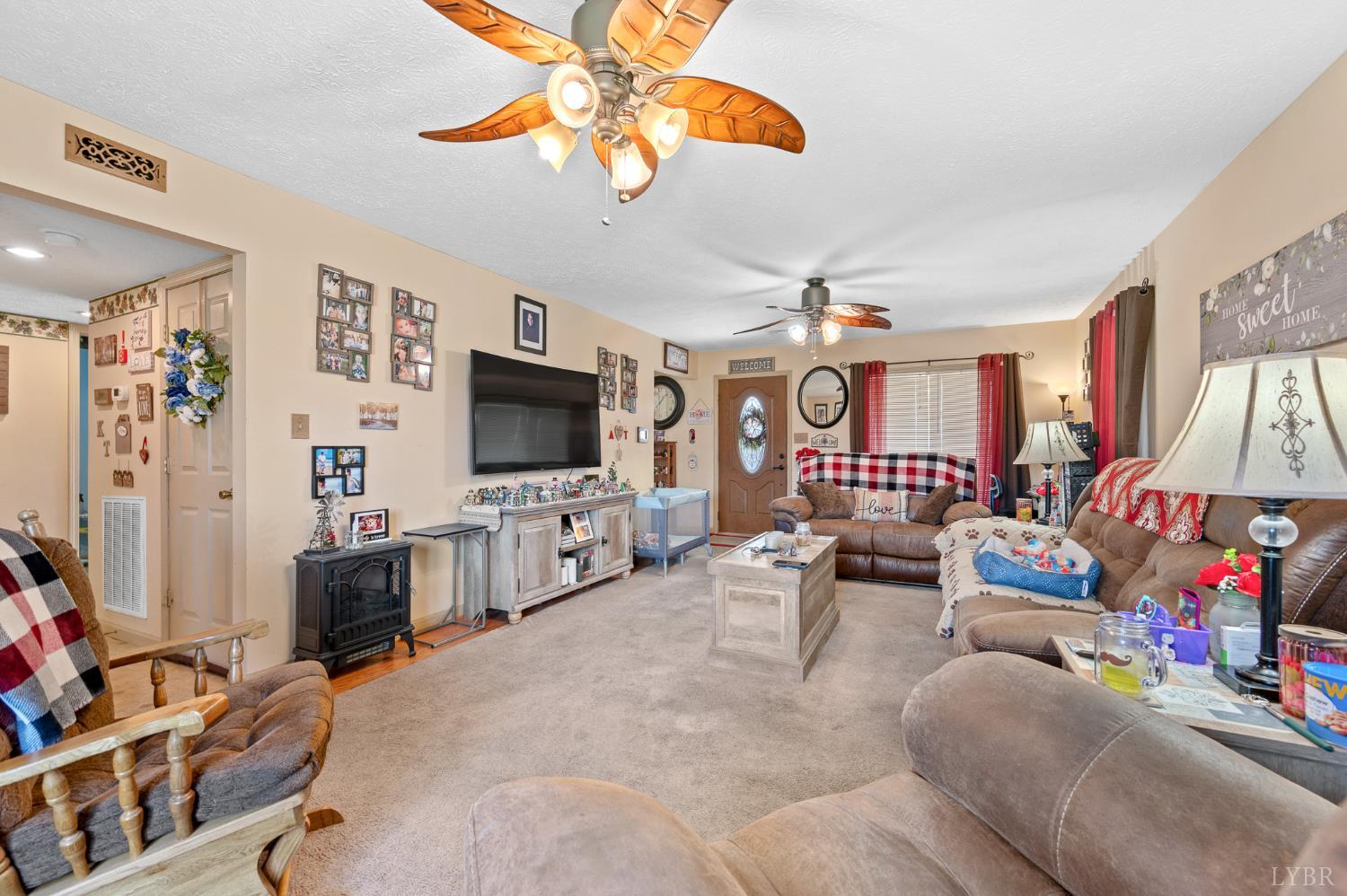 1925 Forbes Mill Road Bedford, VA 24523 - Photo 13 of 58 a living room with furniture and a flat screen tv