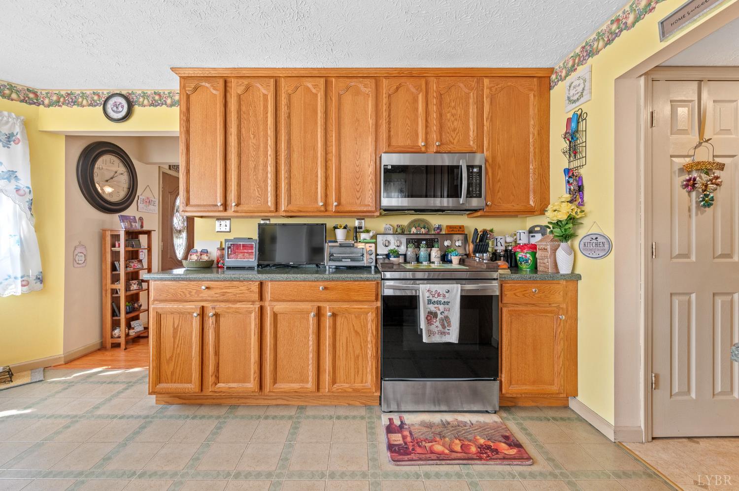 1925 Forbes Mill Road Bedford, VA 24523 - Photo 19 of 58 a kitchen with stainless steel appliances granite countertop a stove a sink and a microwave
