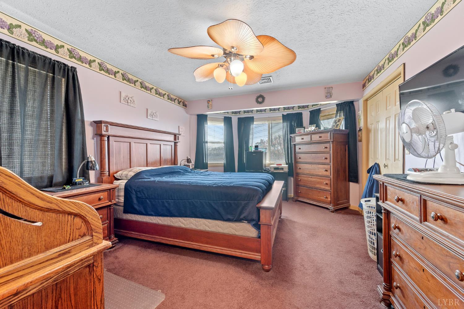 1925 Forbes Mill Road Bedford, VA 24523 - Photo 24 of 58 a bedroom with a bed and a chandelier