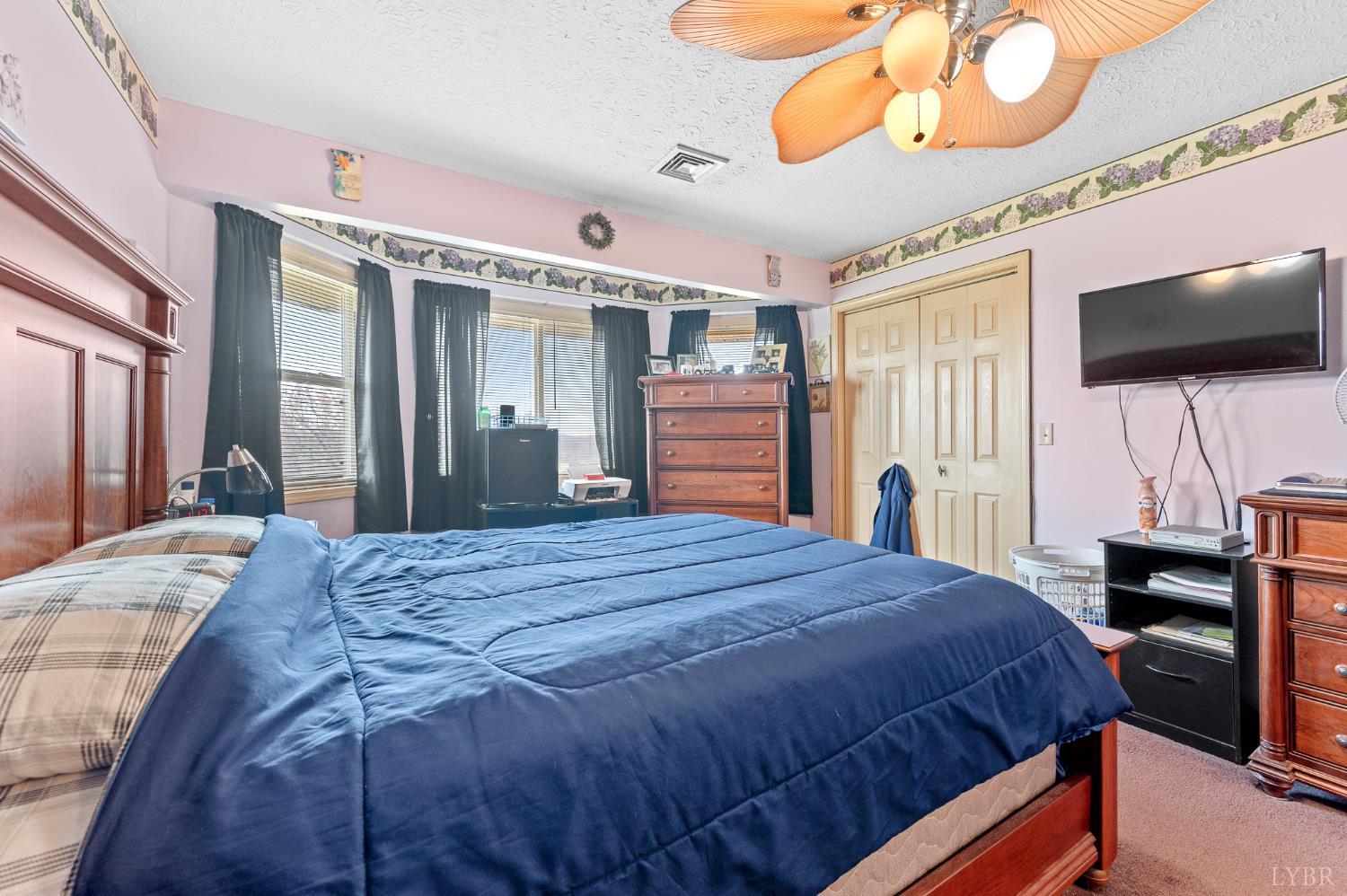 1925 Forbes Mill Road Bedford, VA 24523 - Photo 25 of 58 a bedroom with a bed and a flat screen tv