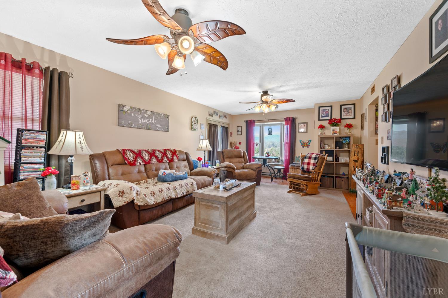 1925 Forbes Mill Road Bedford, VA 24523 - Photo 10 of 58 a living room with furniture kitchen view and a flat screen tv
