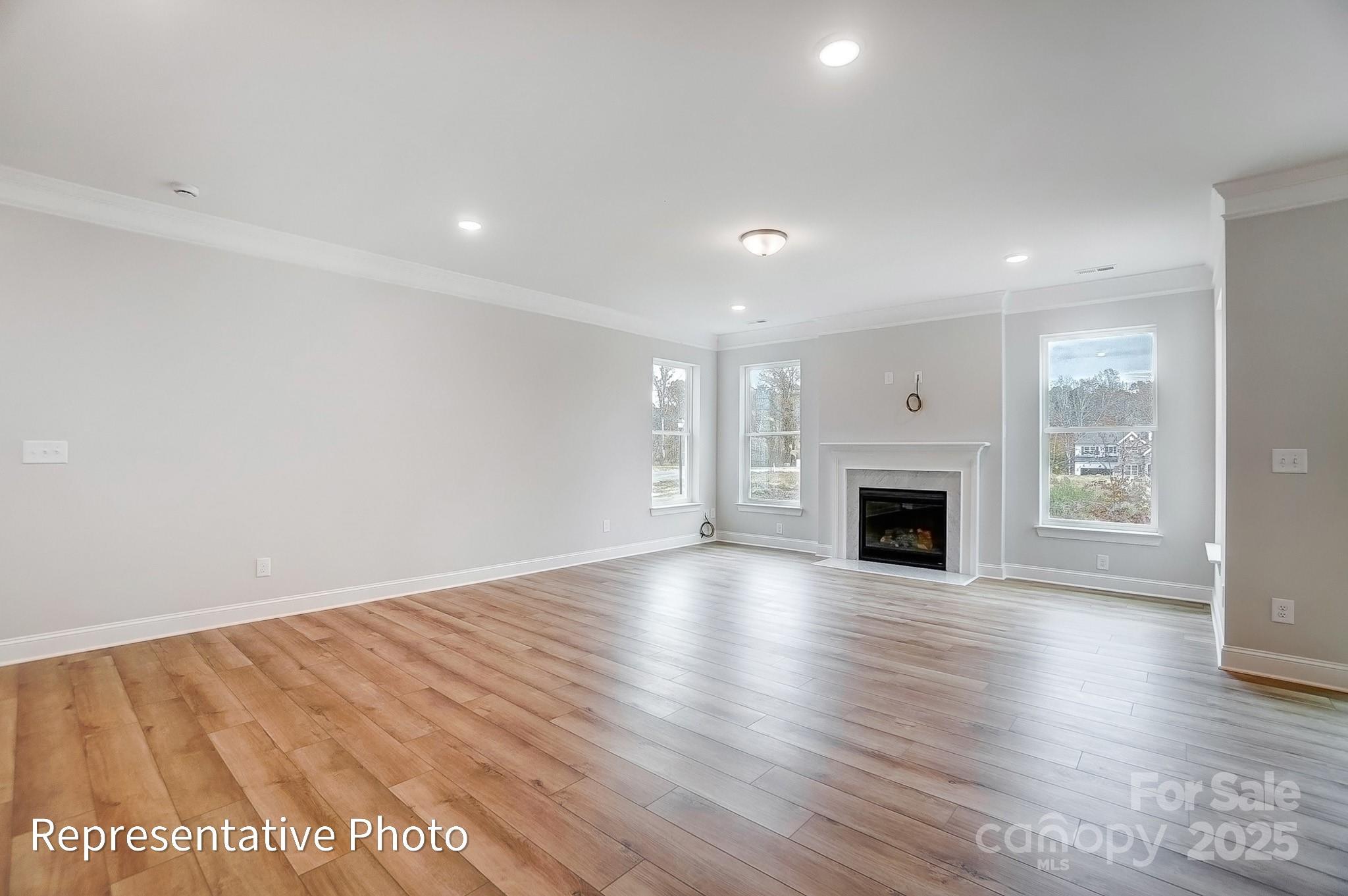 2241 Tabor Road Sherrills Ford, NC 28673 - Photo 12 of 38 a view of empty room with wooden floor and fireplace