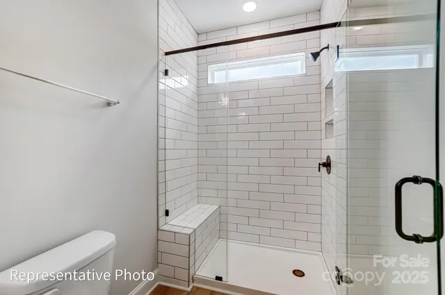 a bathroom with a shower and a toilet