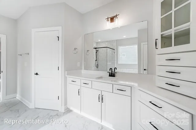 a bathroom with a sink a vanity and a mirror