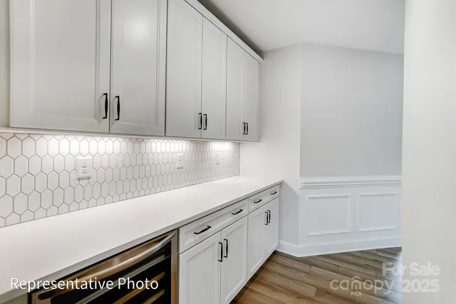 a view of a kitchen with white cabinets