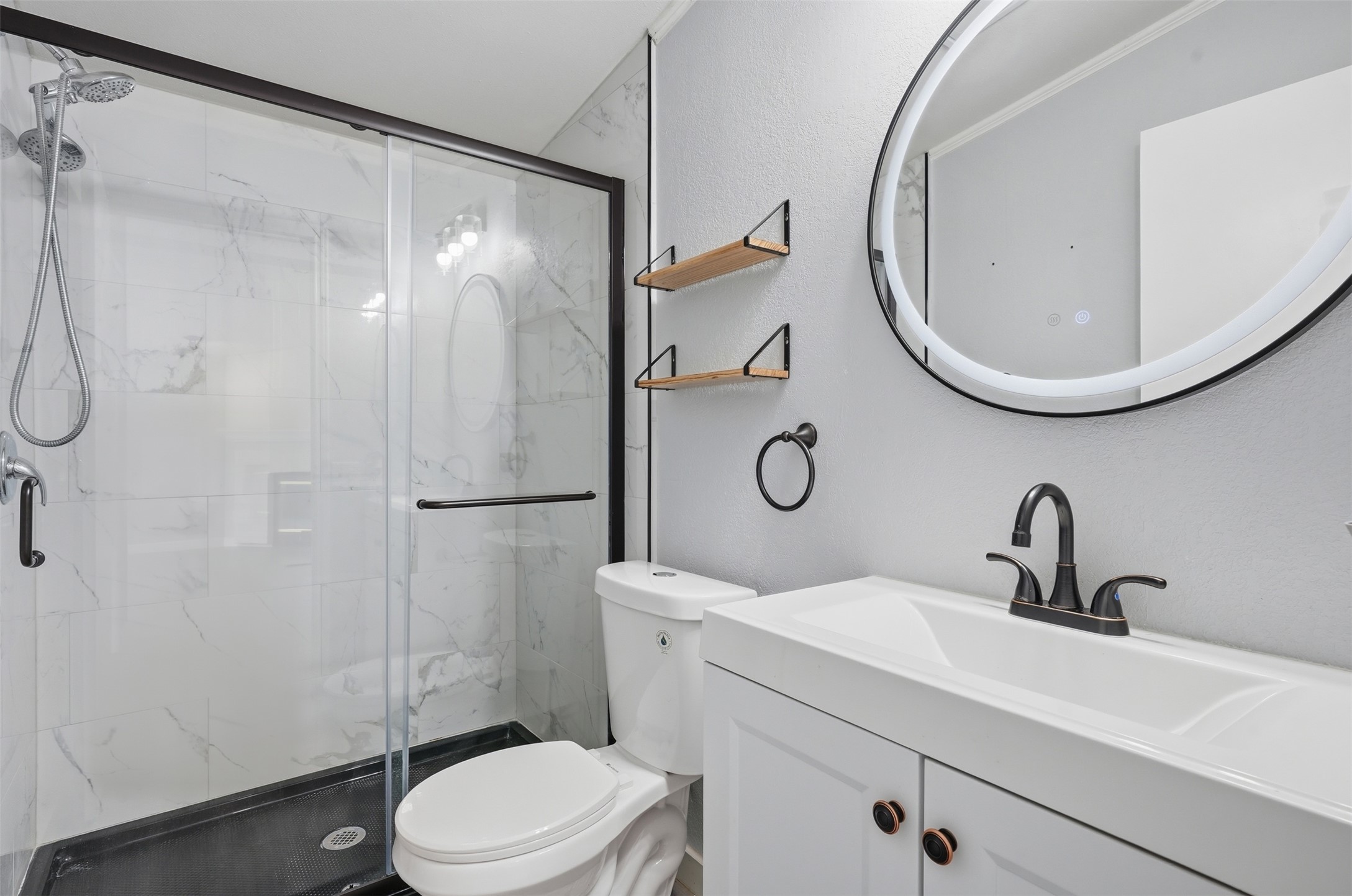 154 Antioch Road Smithville, TX 78957 - Photo 21 of 32 A well-appointed bathroom features a contemporary vanity, sleek shower, and modern fixtures.