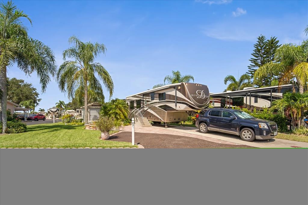 2911 Birdie Drive, Unit 85 Bowling Green, FL 33834 - Photo 4 of 16 a view of a street with a car parked in front of it
