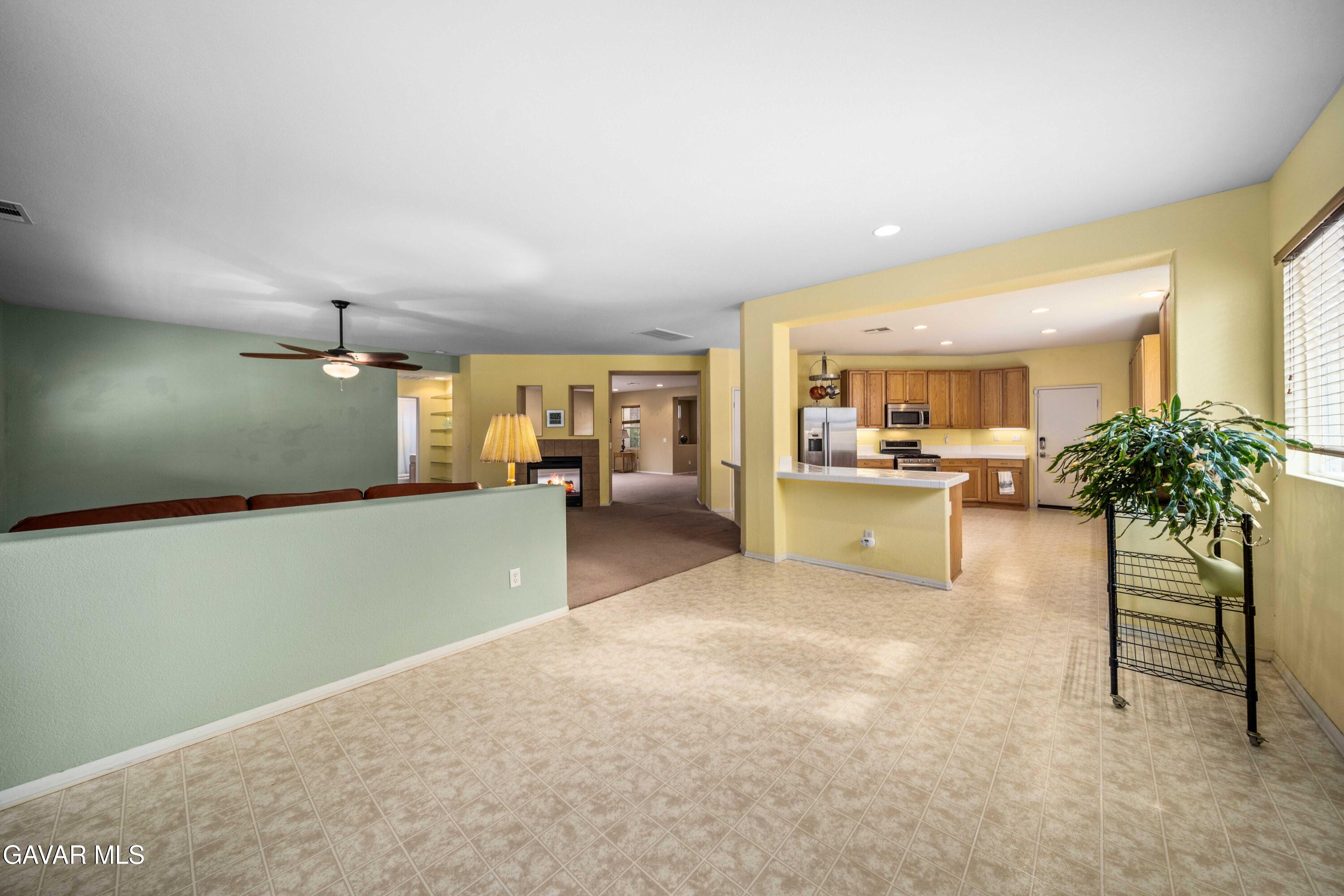43219 Fanchon Avenue Lancaster, CA 93536 - Photo 18 of 51 a view of a livingroom with furniture and a kitchen
