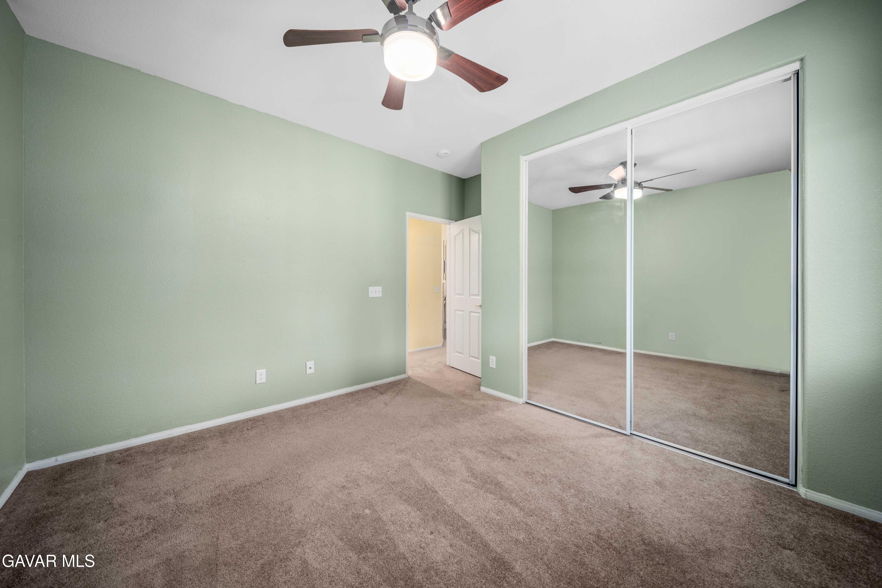 43219 Fanchon Avenue Lancaster, CA 93536 - Photo 22 of 51 an empty room with closet and a chandelier fan