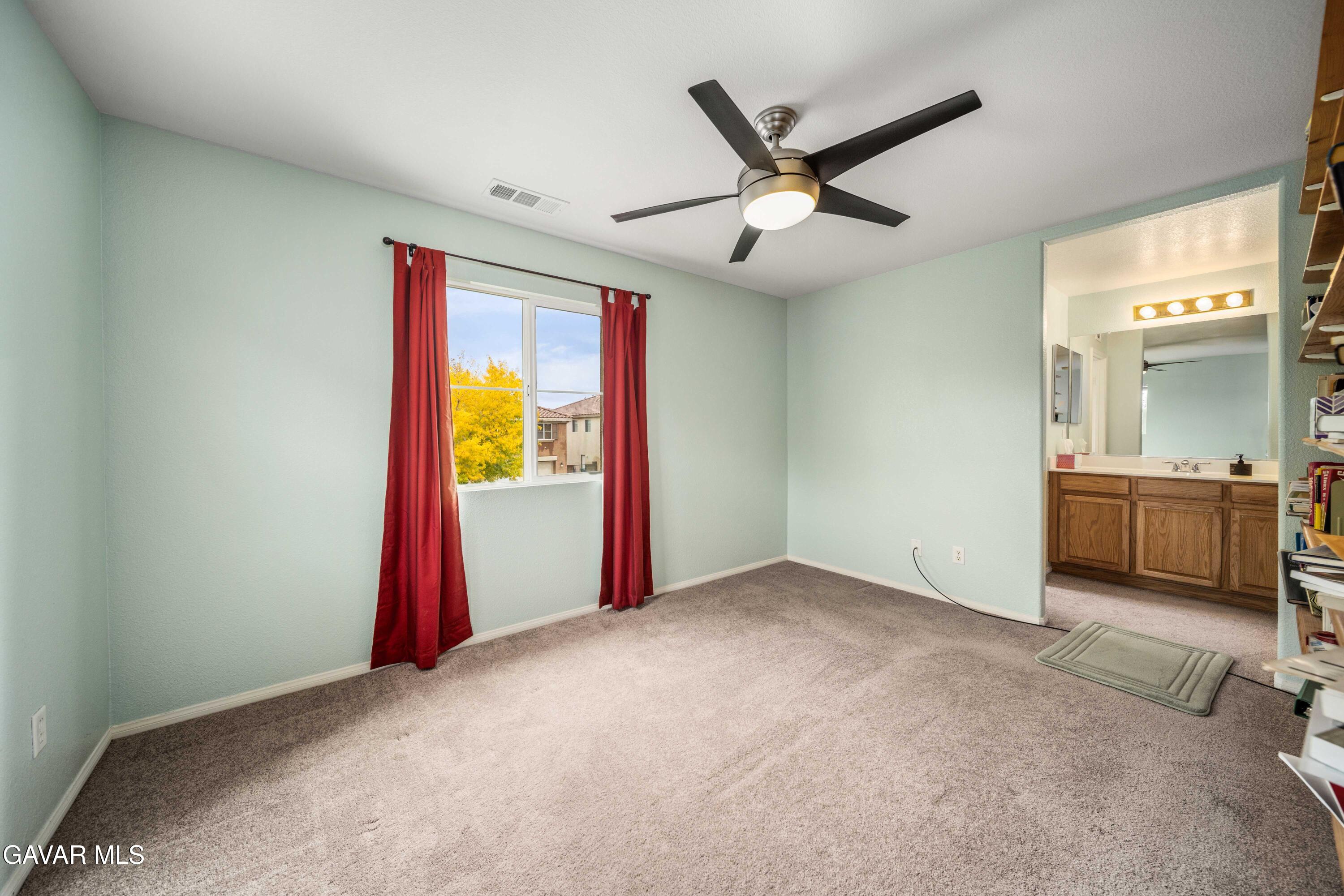 43219 Fanchon Avenue Lancaster, CA 93536 - Photo 24 of 51 a view of a livingroom with a ceiling fan and a window