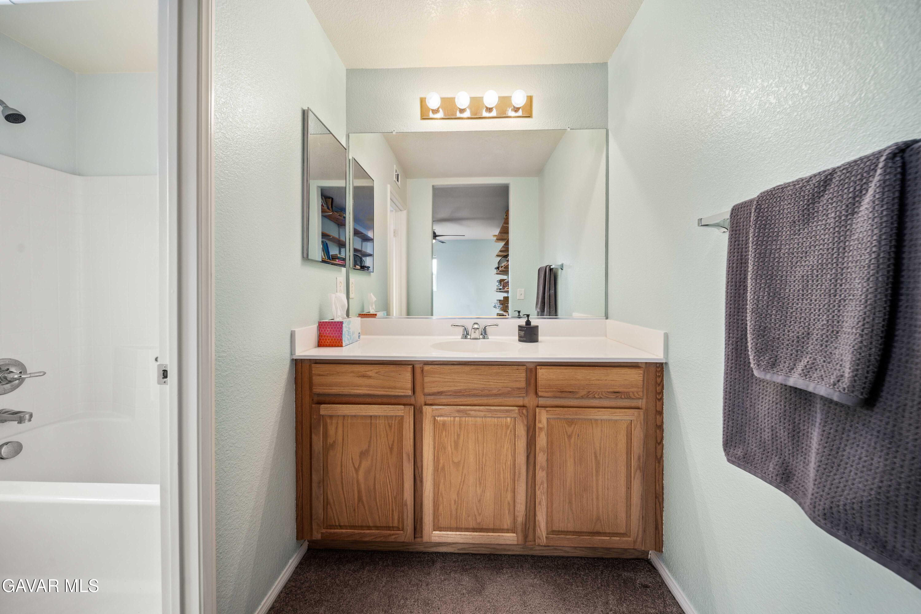 43219 Fanchon Avenue Lancaster, CA 93536 - Photo 26 of 51 a bathroom with a sink and a mirror