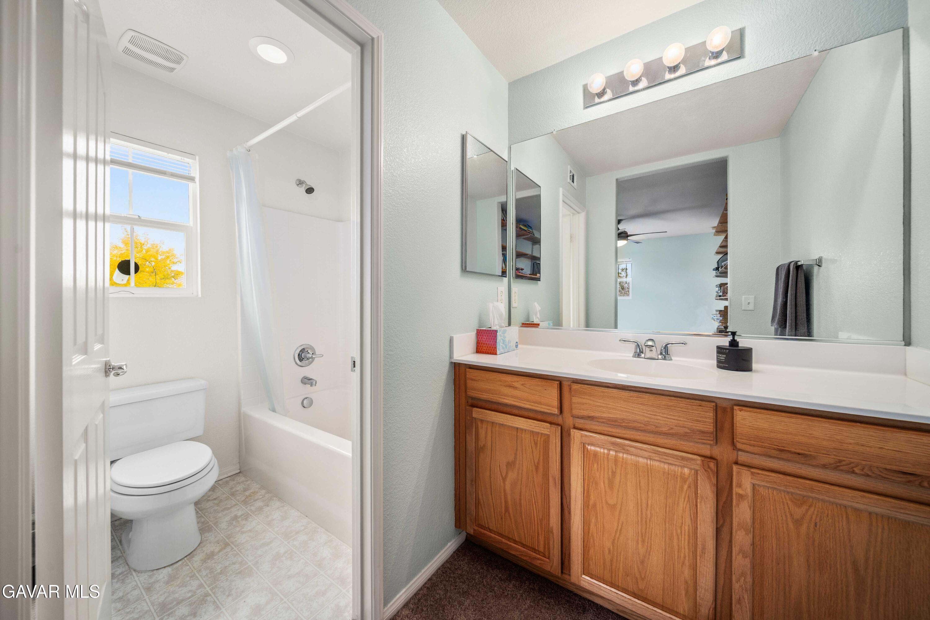 43219 Fanchon Avenue Lancaster, CA 93536 - Photo 27 of 51 a spacious bathroom with a toilet sink and mirror