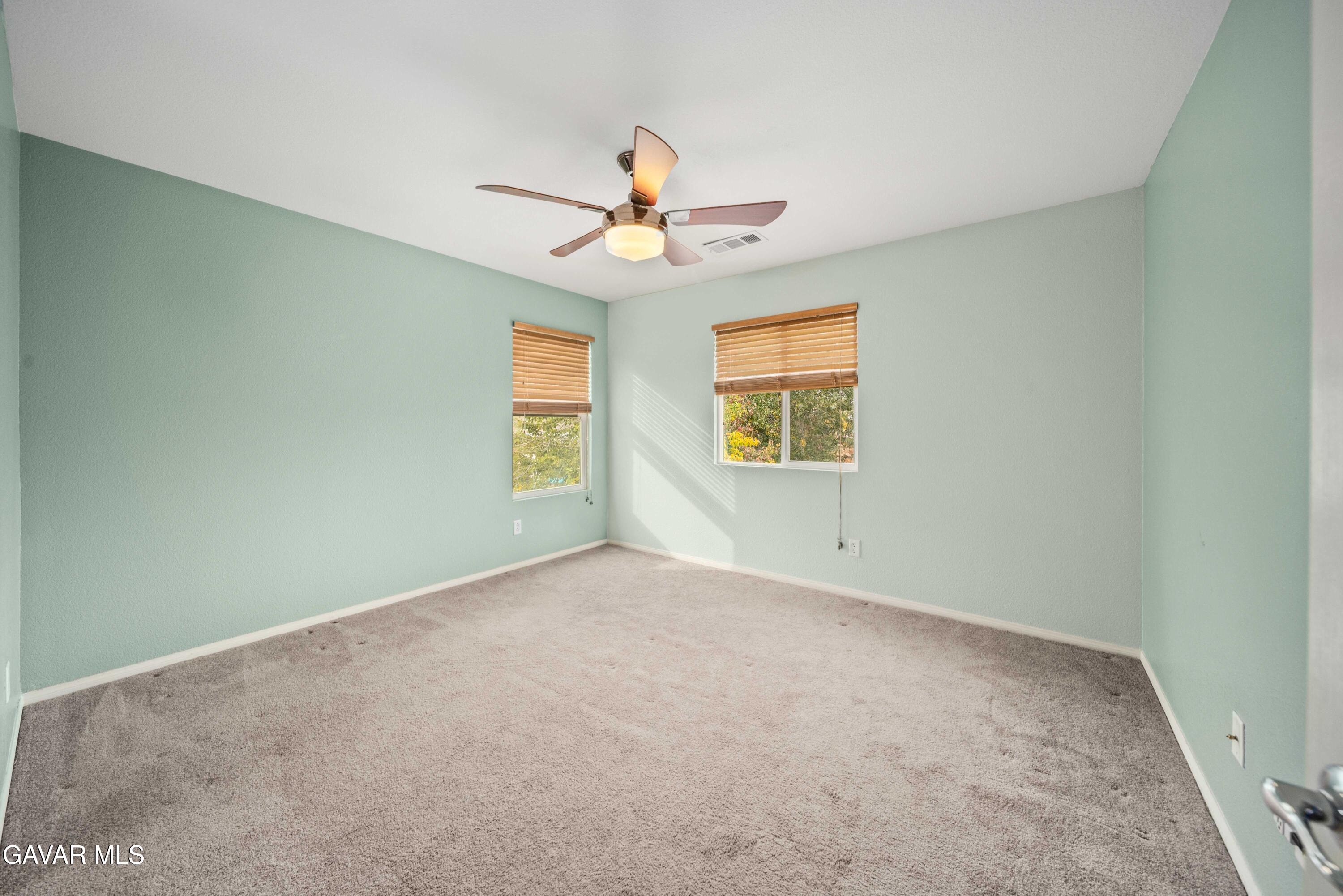 43219 Fanchon Avenue Lancaster, CA 93536 - Photo 33 of 51 an empty room with windows and chandelier fan