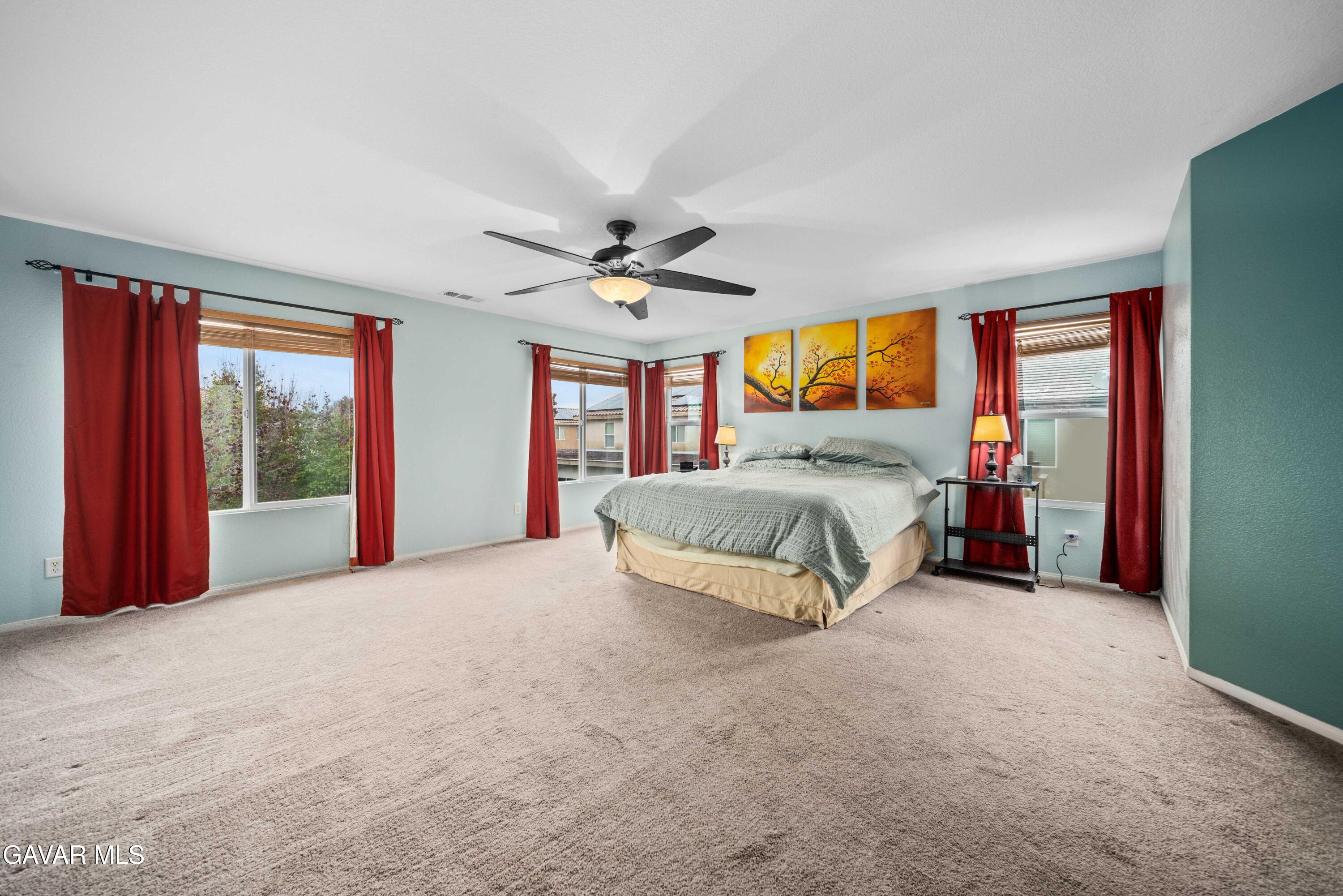 43219 Fanchon Avenue Lancaster, CA 93536 - Photo 39 of 51 a spacious bedroom with a bed and a large window