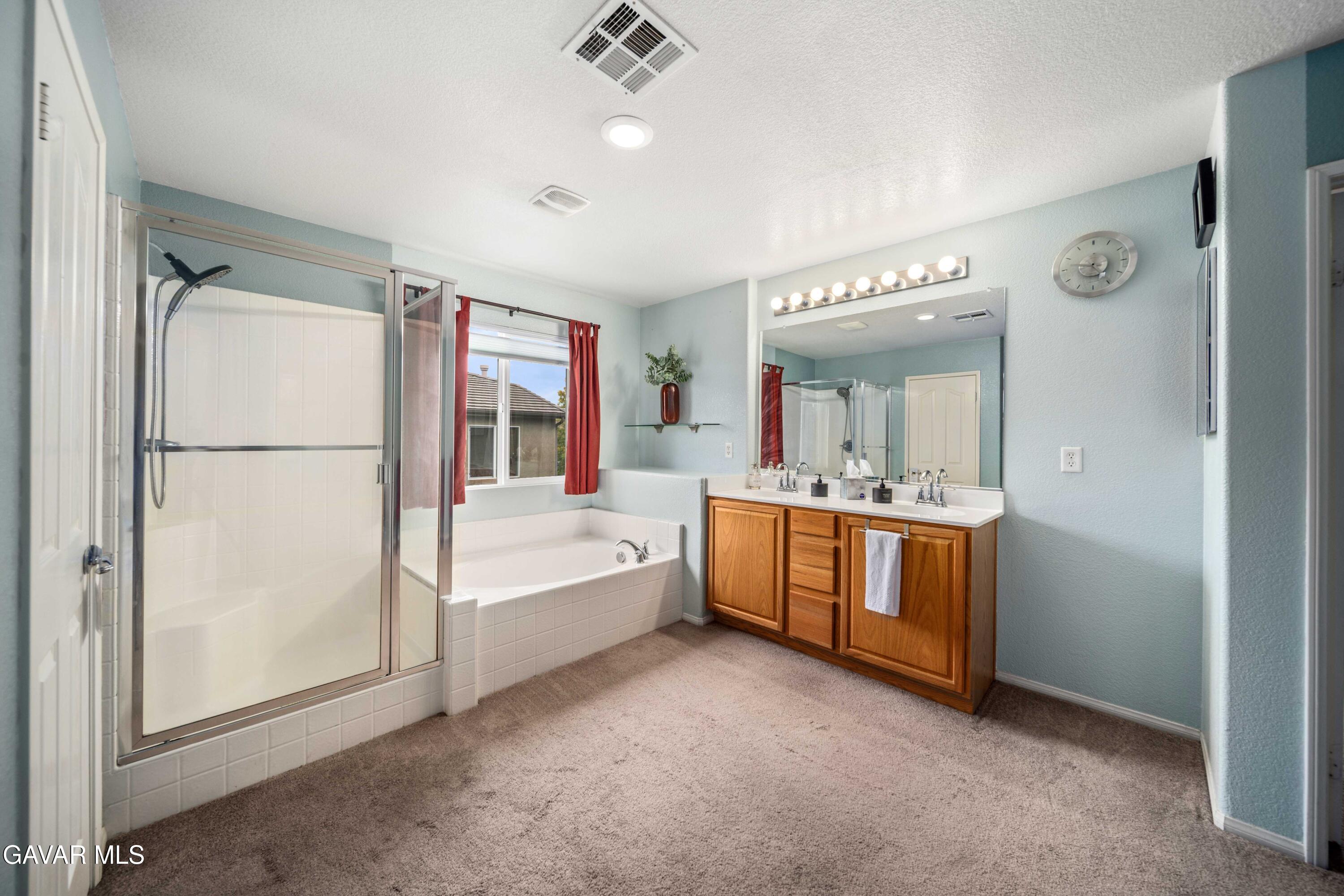 43219 Fanchon Avenue Lancaster, CA 93536 - Photo 43 of 51 a bathroom with a double vanity sink mirror and bathtub