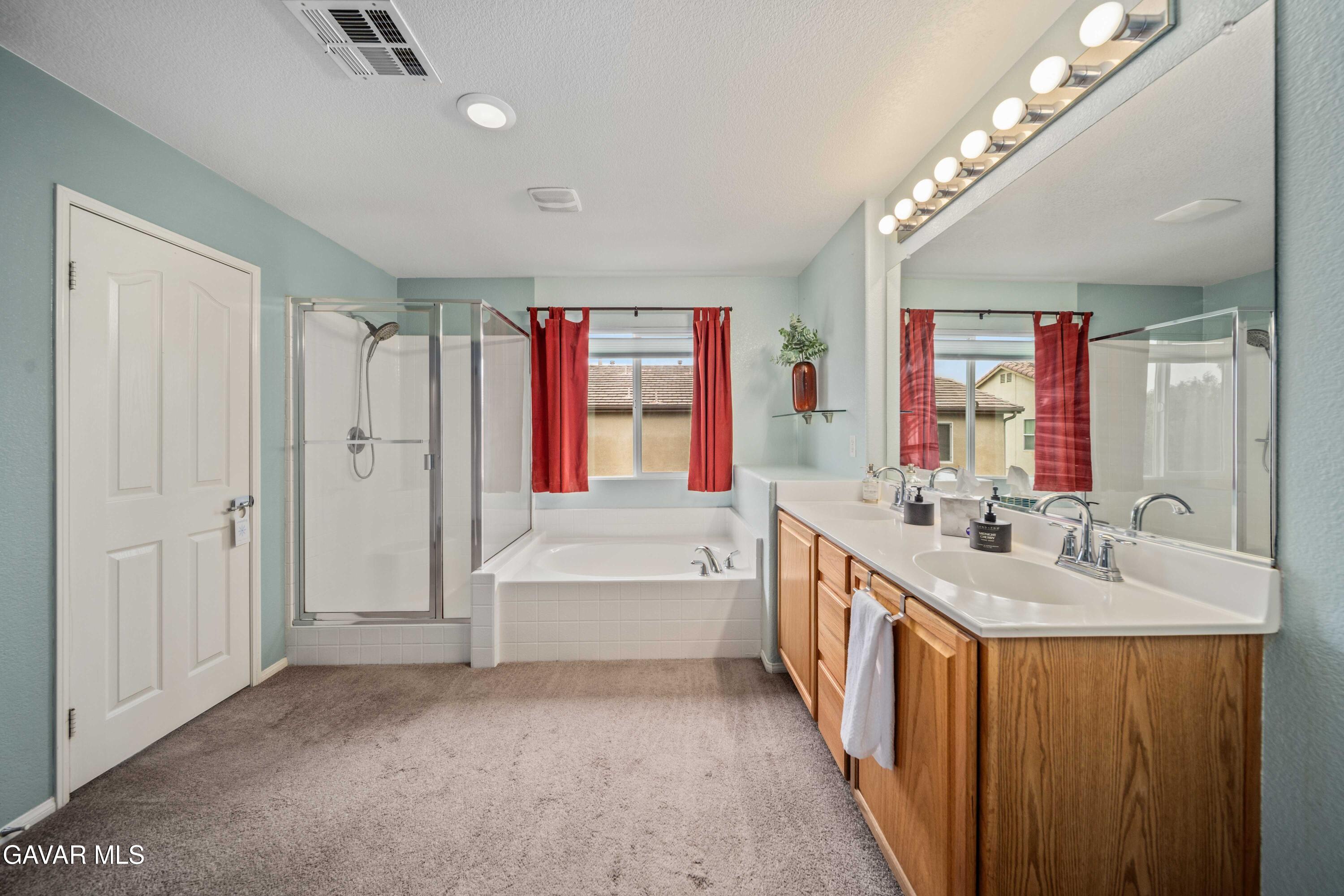 43219 Fanchon Avenue Lancaster, CA 93536 - Photo 47 of 51 a spacious bathroom with a bathtub sink and mirror
