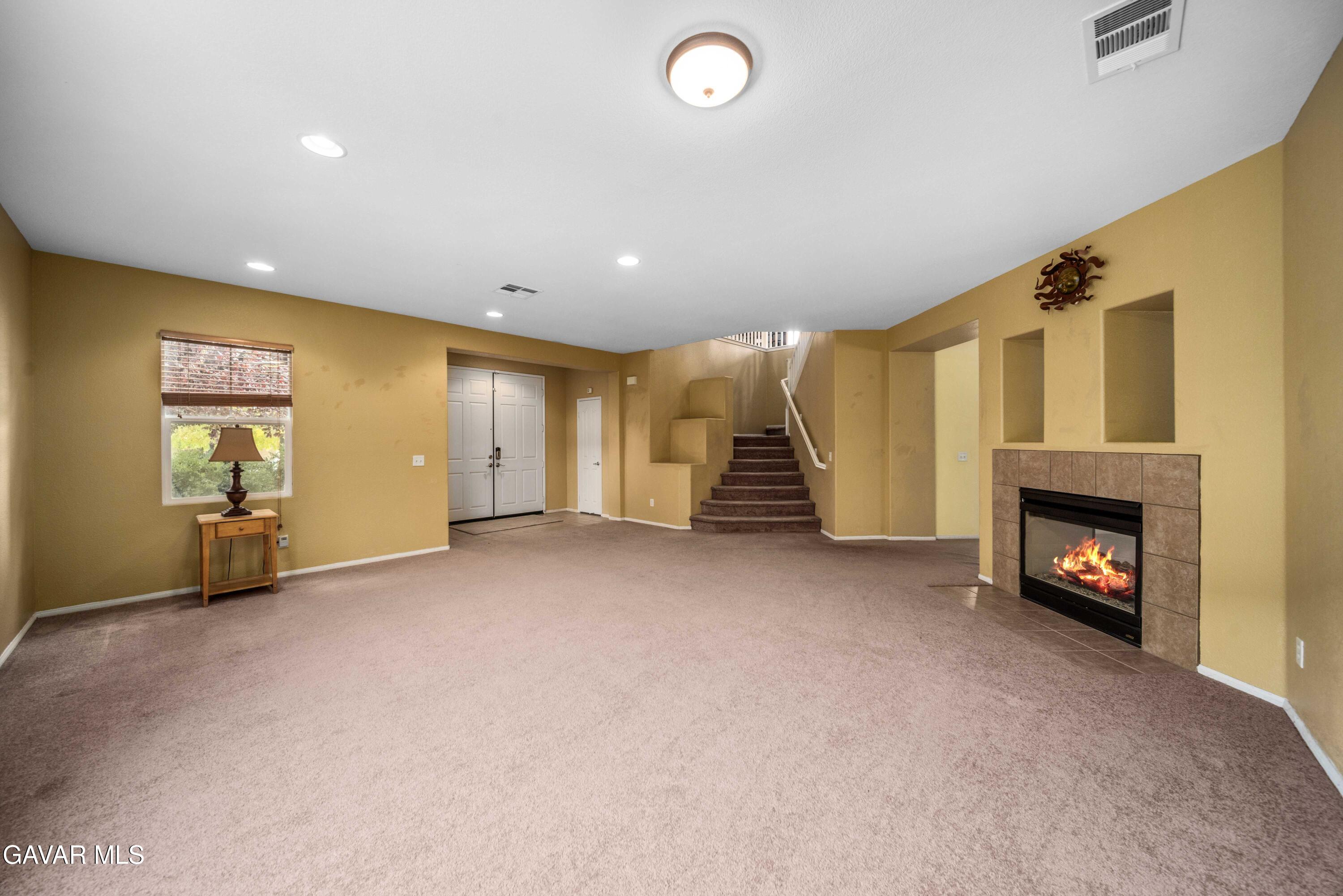 43219 Fanchon Avenue Lancaster, CA 93536 - Photo 6 of 51 an empty room with furniture and a fireplace