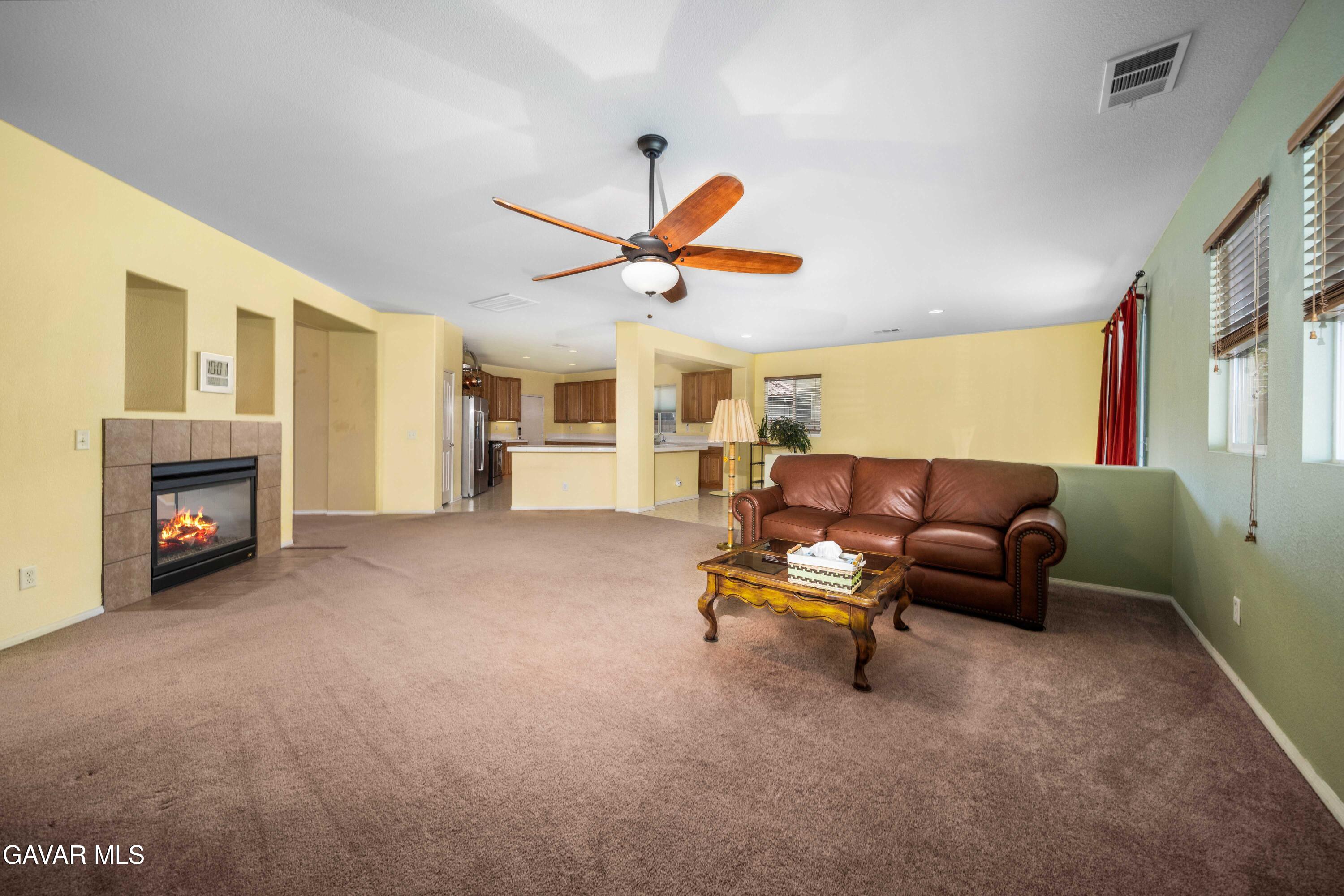43219 Fanchon Avenue Lancaster, CA 93536 - Photo 7 of 51 a living room with furniture and a fireplace
