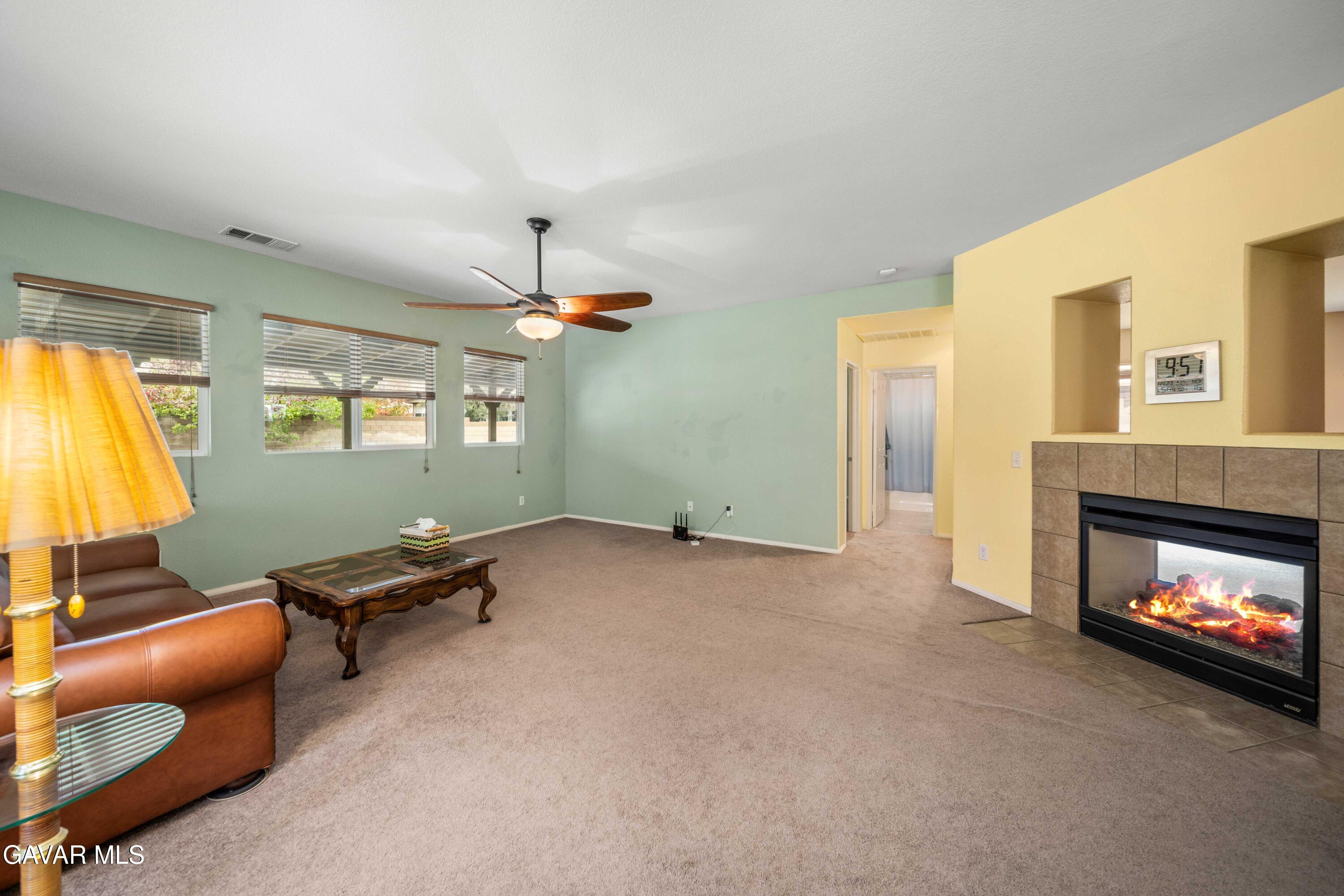 43219 Fanchon Avenue Lancaster, CA 93536 - Photo 8 of 51 a living room with furniture and a fireplace