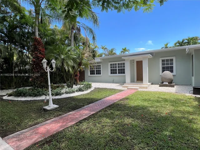 a house view with a sitting space and garden