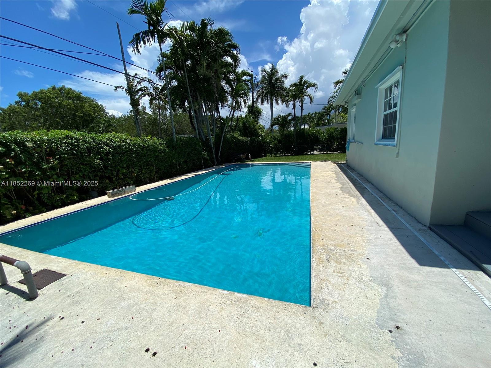 5940 Southwest 47th Street Miami, FL 33155 - Photo 2 of 15 a view of a swimming pool with a yard