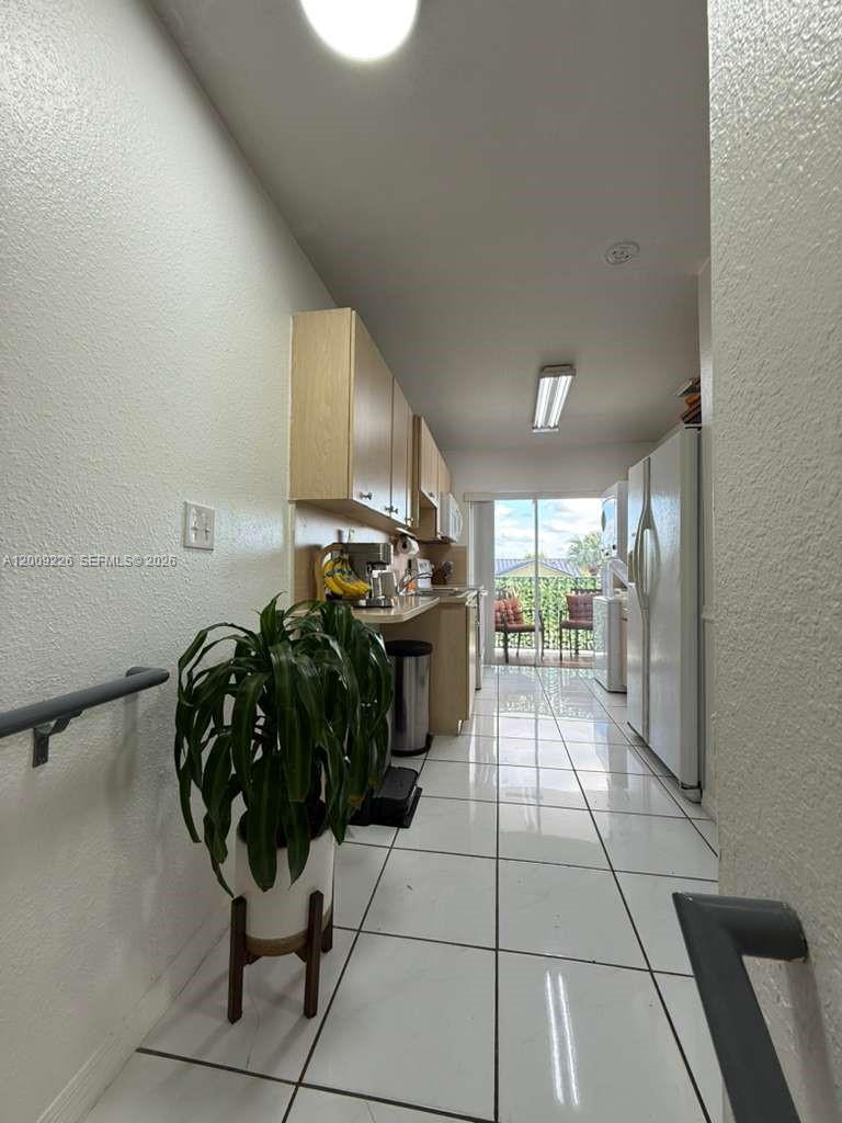 3514 West 76th Street, Unit 203 Hialeah, FL 33018 - Photo 11 of 39 a kitchen with a sink and cabinets