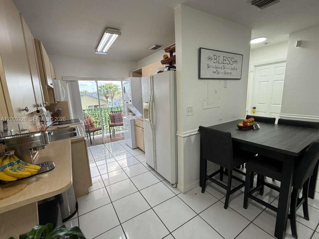 3514 West 76th Street, Unit 203 Hialeah, FL 33018 - Photo 12 of 39 a kitchen with a sink refrigerator and cabinets