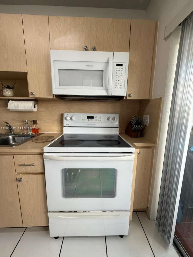 3514 West 76th Street, Unit 203 Hialeah, FL 33018 - Photo 16 of 39 a stove top oven sitting inside of a kitchen