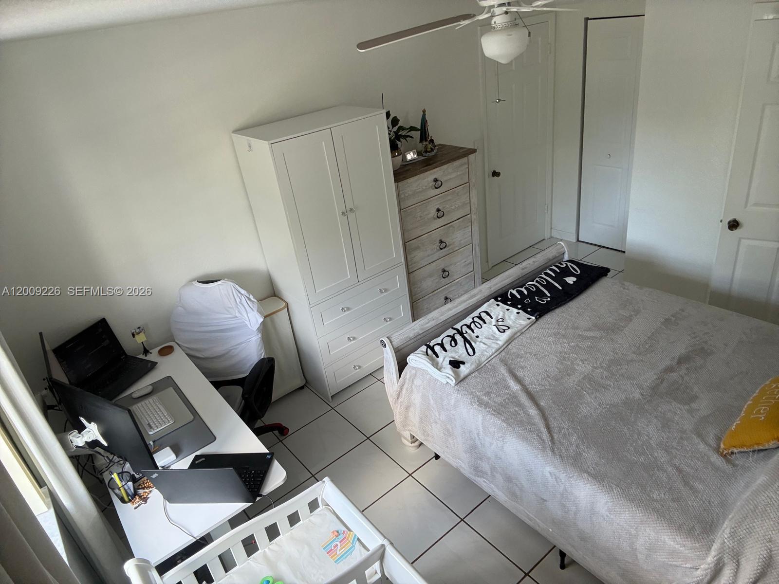 3514 West 76th Street, Unit 203 Hialeah, FL 33018 - Photo 22 of 39 a bedroom with a bed and cabinets