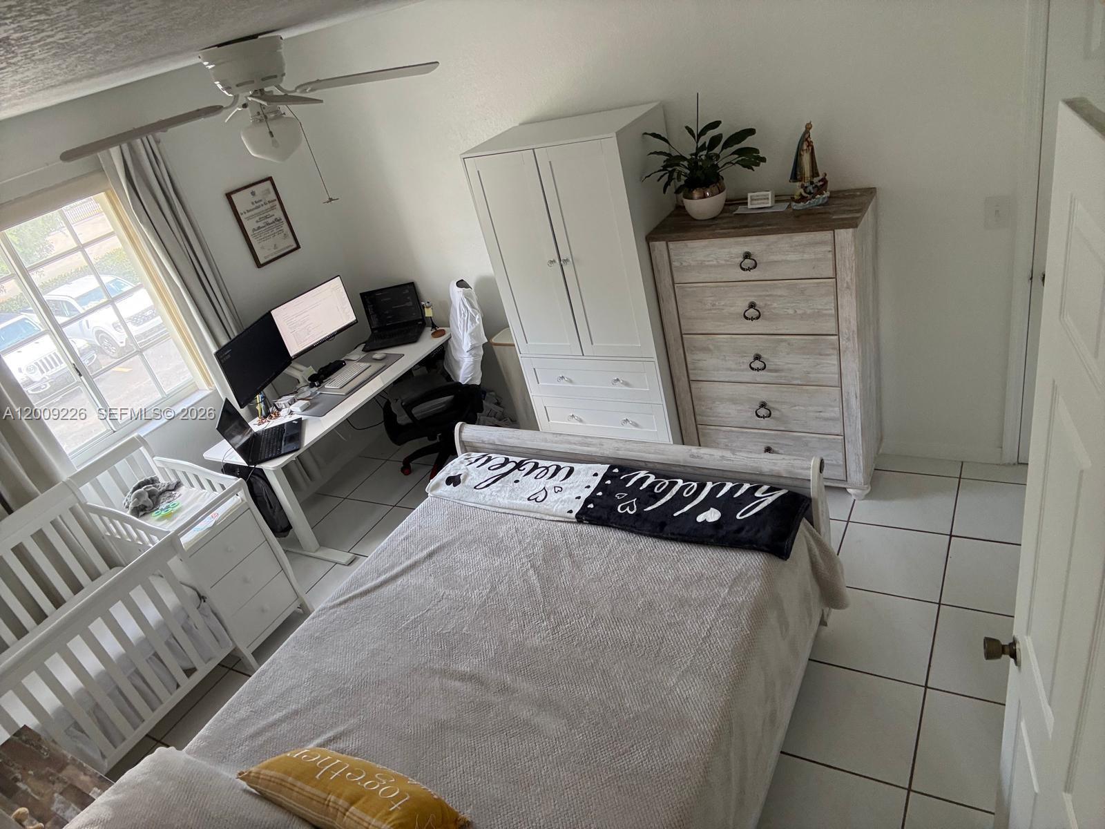 3514 West 76th Street, Unit 203 Hialeah, FL 33018 - Photo 23 of 39 a bedroom with a bed and cabinets