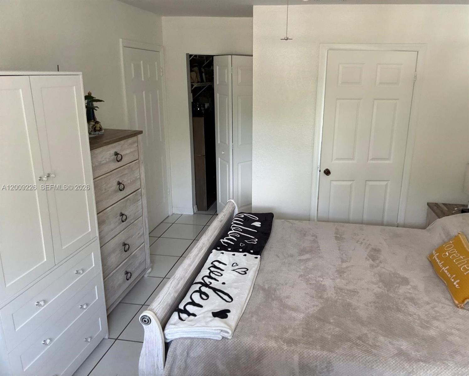 3514 West 76th Street, Unit 203 Hialeah, FL 33018 - Photo 24 of 39 a bedroom with a bed and a cabinets