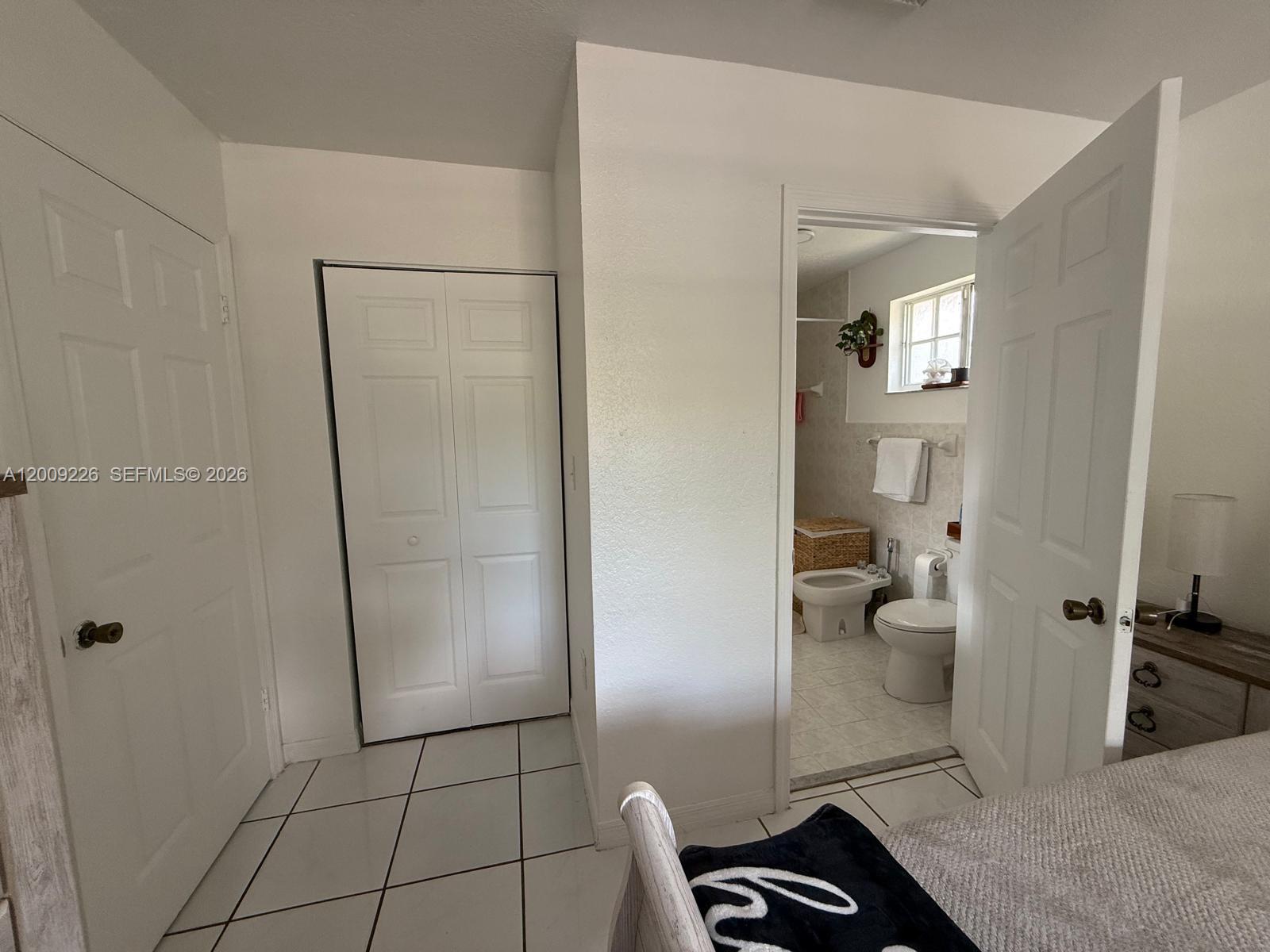 3514 West 76th Street, Unit 203 Hialeah, FL 33018 - Photo 25 of 39 a bathroom with a granite countertop shower and a toilet
