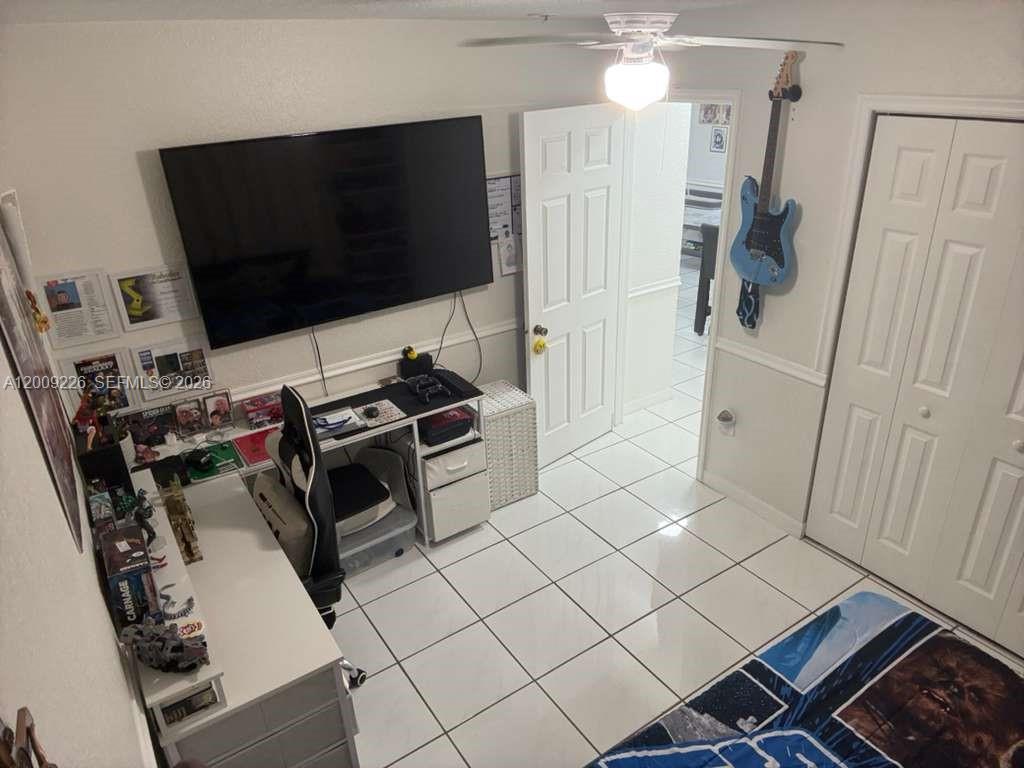 3514 West 76th Street, Unit 203 Hialeah, FL 33018 - Photo 26 of 39 a living room with furniture and a flat screen tv