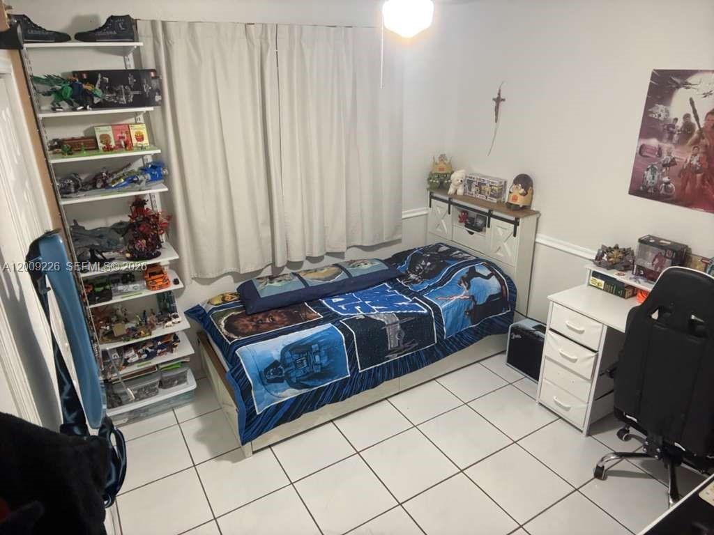 3514 West 76th Street, Unit 203 Hialeah, FL 33018 - Photo 28 of 39 a bedroom with a bed and a window