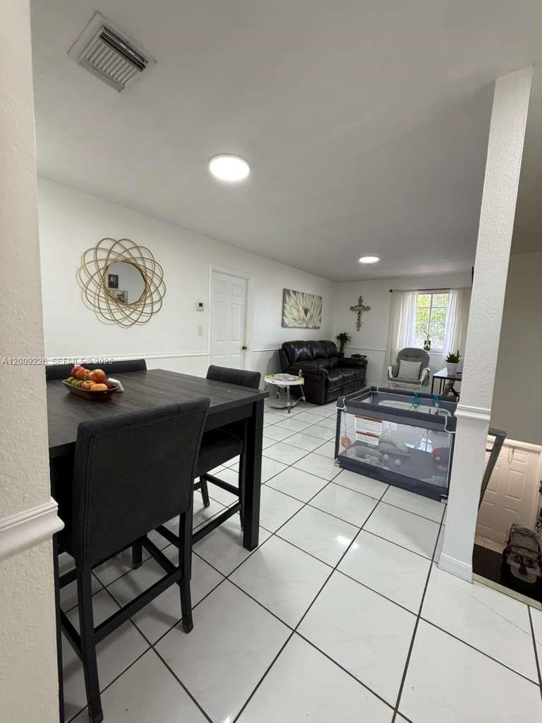 3514 West 76th Street, Unit 203 Hialeah, FL 33018 - Photo 3 of 39 a kitchen with a table and chairs in it