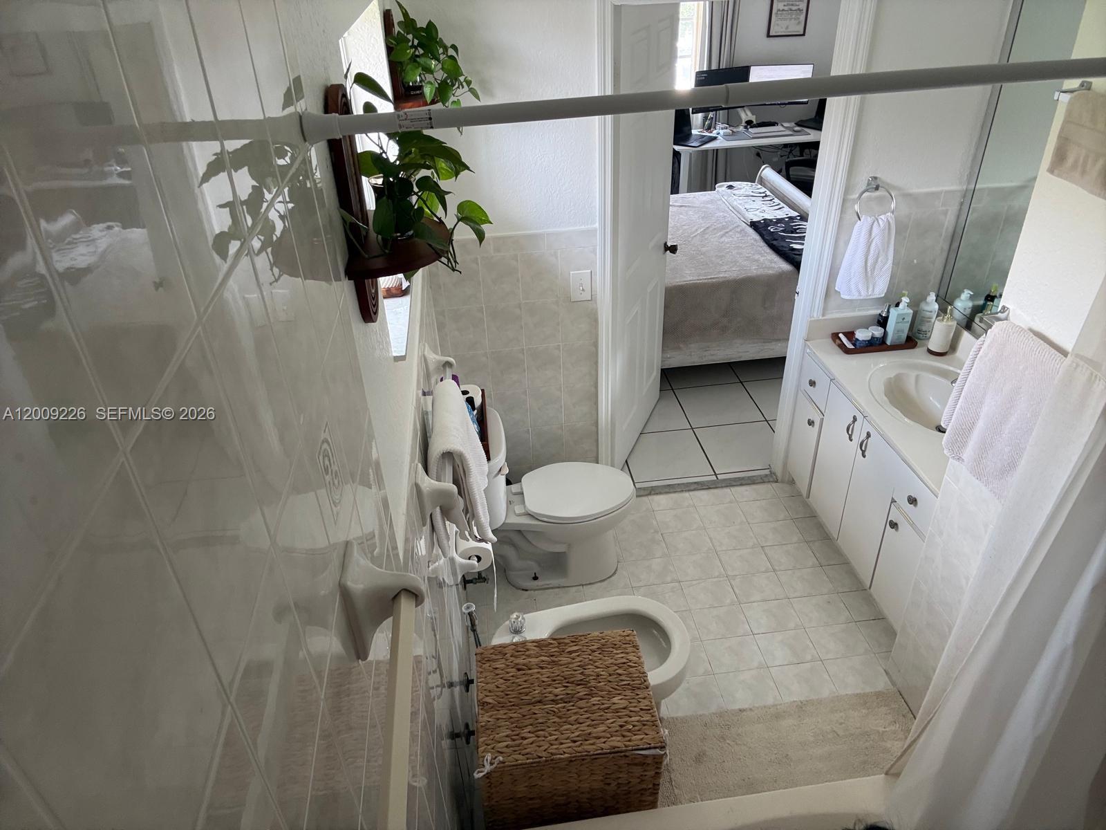 3514 West 76th Street, Unit 203 Hialeah, FL 33018 - Photo 32 of 39 a bathroom with a granite countertop sink a toilet and shower