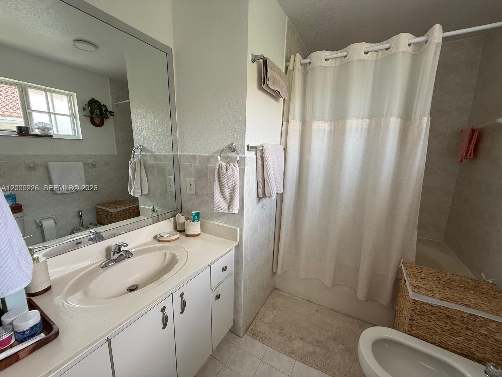 3514 West 76th Street, Unit 203 Hialeah, FL 33018 - Photo 33 of 39 a bathroom with double vanity sink and mirror