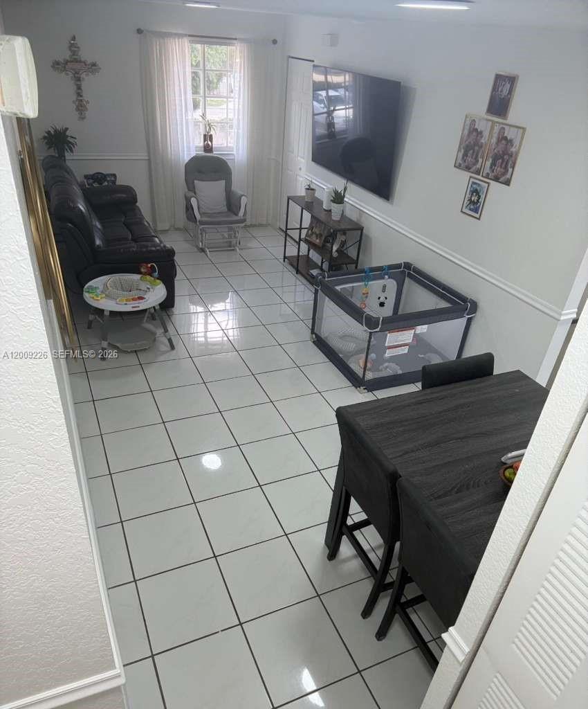 3514 West 76th Street, Unit 203 Hialeah, FL 33018 - Photo 5 of 39 a living room with furniture
