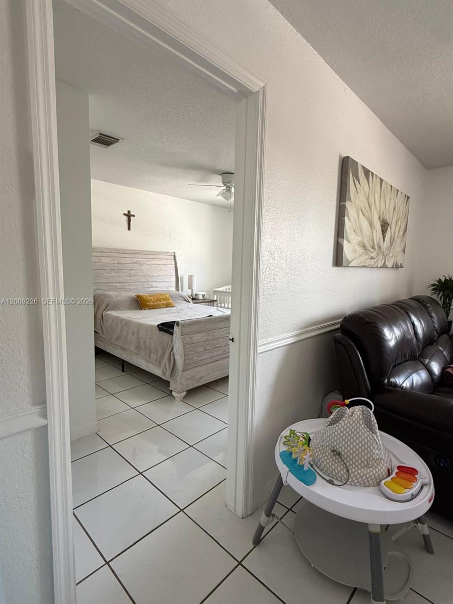 3514 West 76th Street, Unit 203 Hialeah, FL 33018 - Photo 7 of 39 a living room with furniture and a table