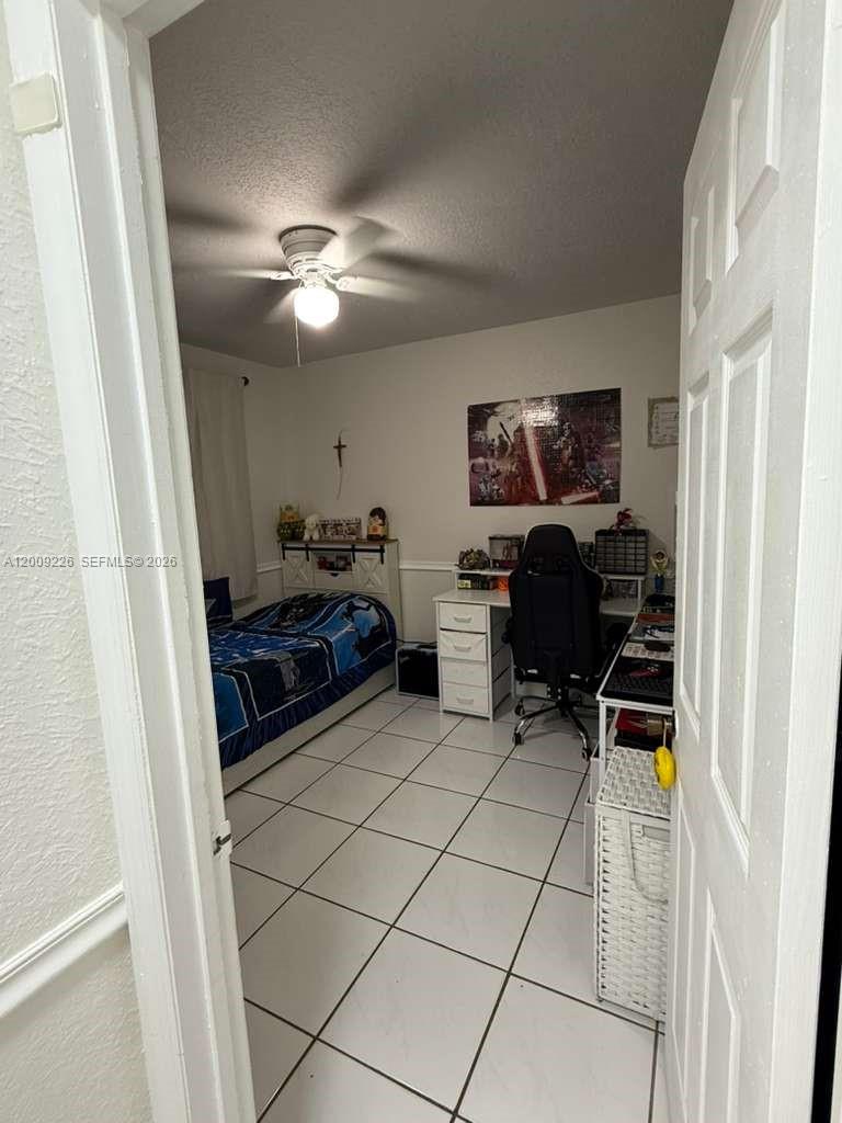 3514 West 76th Street, Unit 203 Hialeah, FL 33018 - Photo 9 of 39 a living room with furniture and a flat screen tv