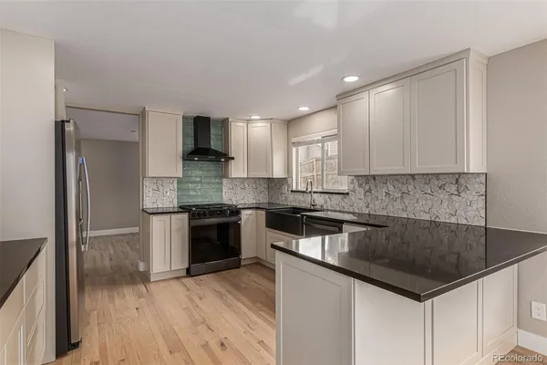 a kitchen with granite countertop a sink and steel stainless steel appliances